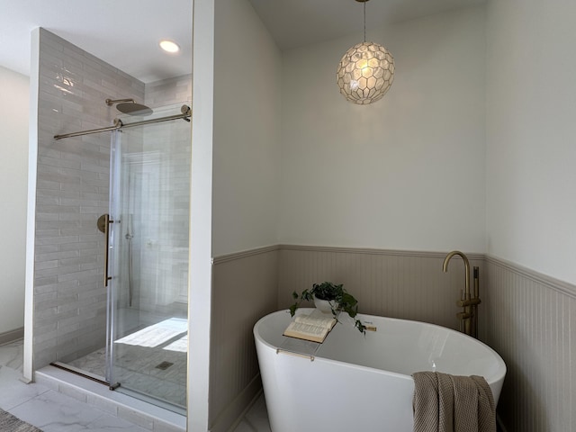 bathroom featuring shower with separate bathtub