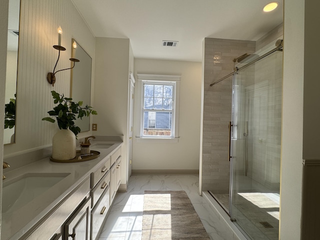 bathroom featuring walk in shower and vanity