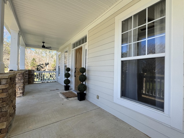 view of patio with ceiling fan and a porch