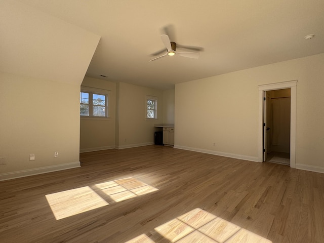 unfurnished living room with ceiling fan and light wood-type flooring