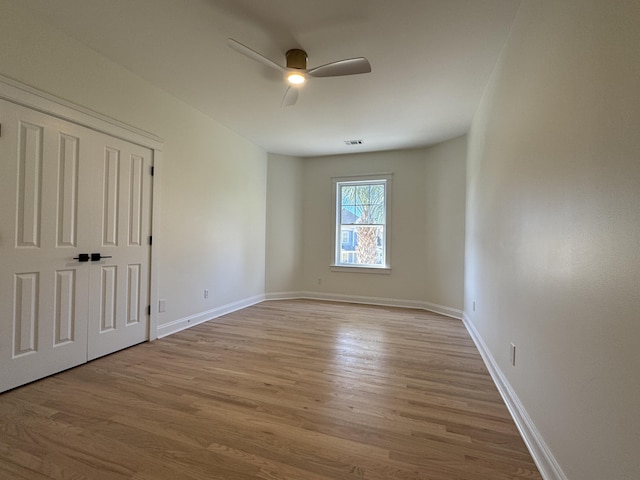 unfurnished bedroom with ceiling fan and light hardwood / wood-style floors