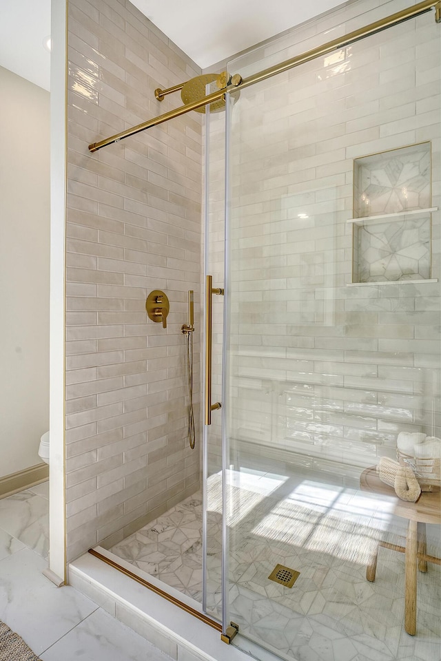 bathroom featuring a shower with door