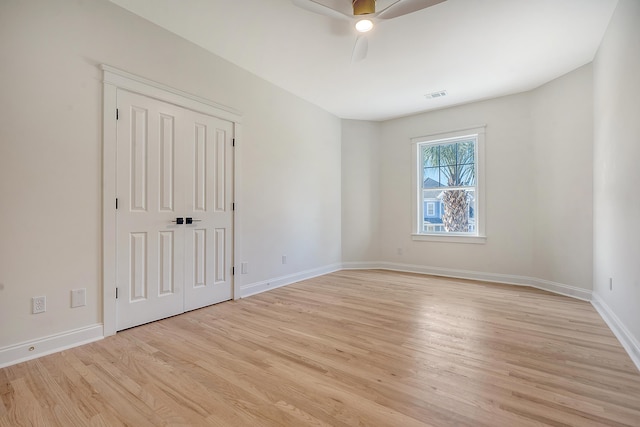 empty room featuring ceiling fan and light hardwood / wood-style floors