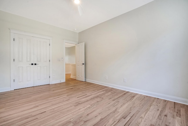 unfurnished bedroom with ceiling fan, light hardwood / wood-style floors, and a closet