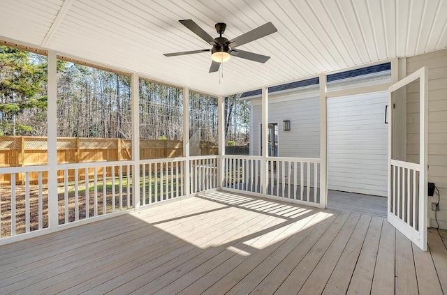 unfurnished sunroom with ceiling fan