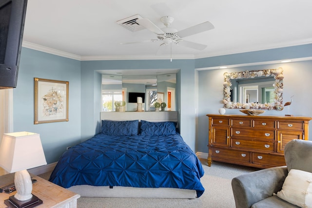 carpeted bedroom featuring crown molding and ceiling fan