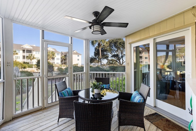 sunroom featuring a healthy amount of sunlight and ceiling fan