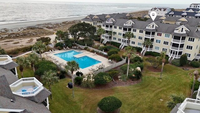 drone / aerial view featuring a water view and a beach view