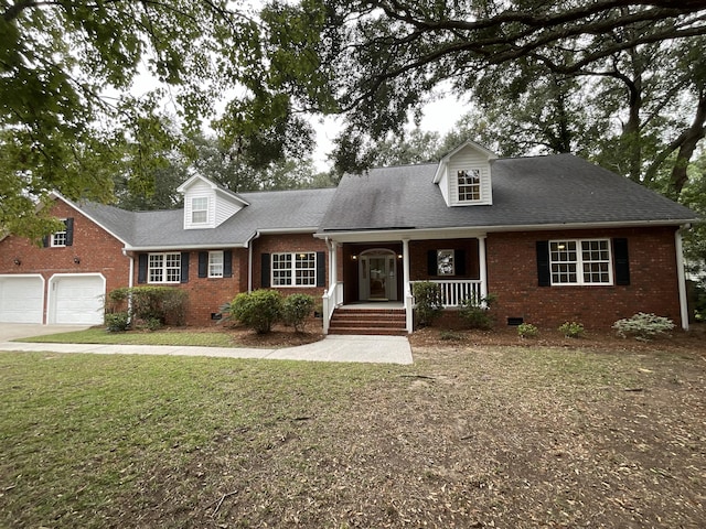 cape cod home with a porch, a front yard, crawl space, and brick siding