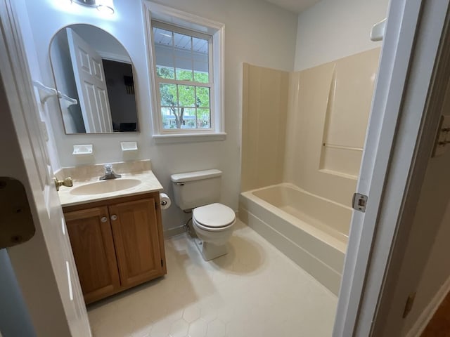 full bath featuring bathing tub / shower combination, vanity, toilet, and baseboards