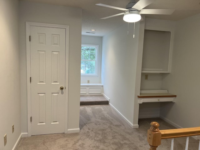 hall with carpet and baseboards