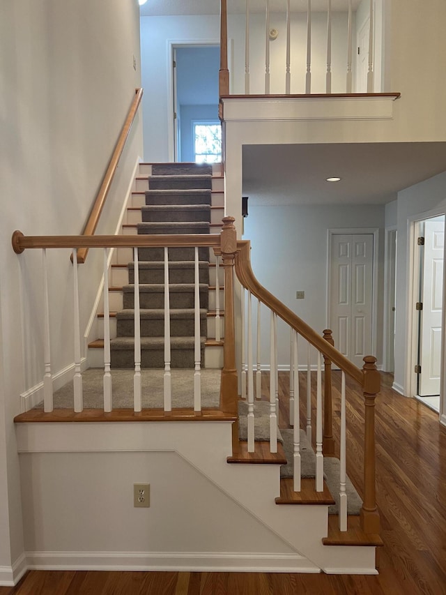 stairway featuring baseboards and wood finished floors