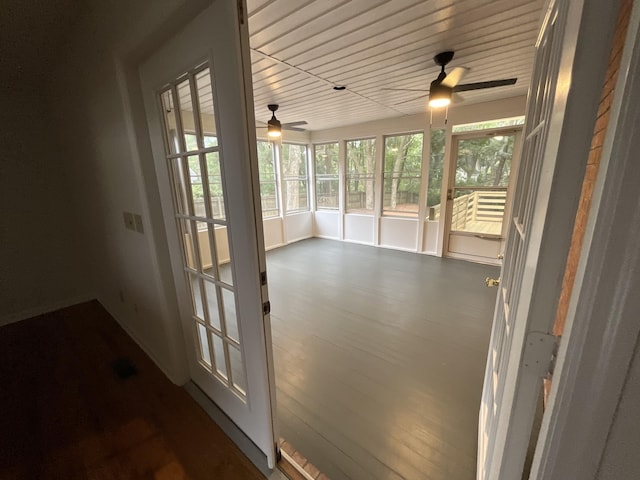 unfurnished sunroom featuring a ceiling fan