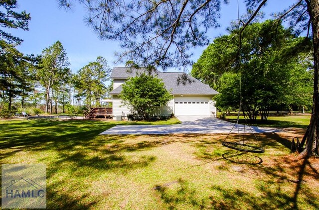 4800 Bay Branch Church Rd, Claxton, GA 30417 - view of property exterior featuring a lawn, a deck, and concrete driveway