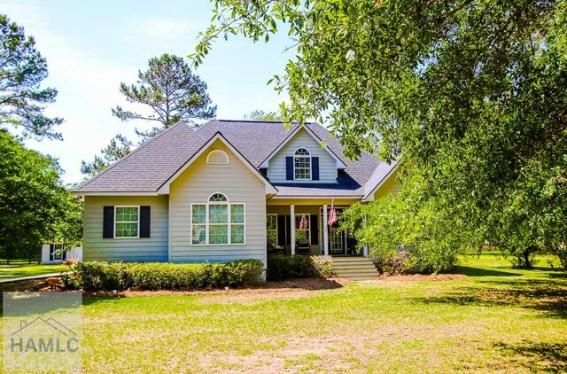 4800 Bay Branch Church Rd, Claxton, GA 30417 - traditional-style home featuring a porch, a front yard, and roof with shingles
