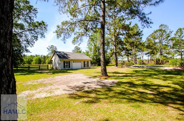 4800 Bay Branch Church Rd, Claxton, GA 30417 - view of yard featuring a detached garage and driveway