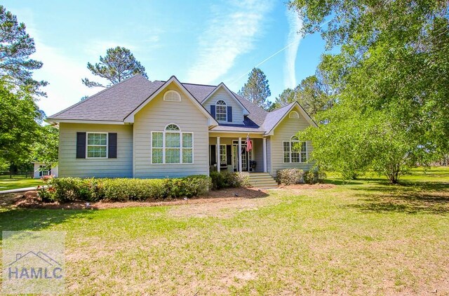 4800 Bay Branch Church Rd, Claxton, GA 30417 - traditional home with a front yard, a porch, and a shingled roof