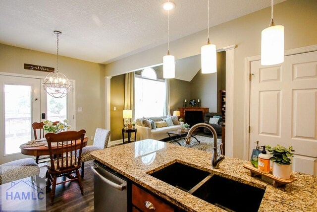 4800 Bay Branch Church Rd, Claxton, GA 30417 - kitchen with a sink, dishwasher, dark wood-style flooring, decorative light fixtures, and light stone countertops