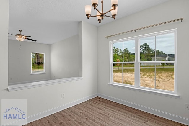 333 Grayson Ave, Hinesville, GA 31313 - spare room featuring a chandelier, wood finished floors, baseboards, and ceiling fan