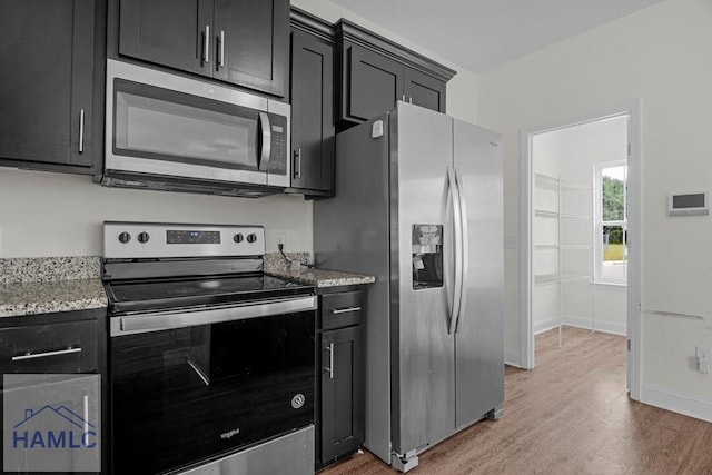 333 Grayson Ave, Hinesville, GA 31313 - kitchen with appliances with stainless steel finishes, dark cabinetry, and light wood-type flooring