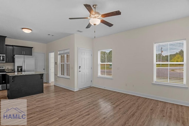 333 Grayson Ave, Hinesville, GA 31313 - unfurnished living room featuring light wood finished floors, baseboards, and ceiling fan