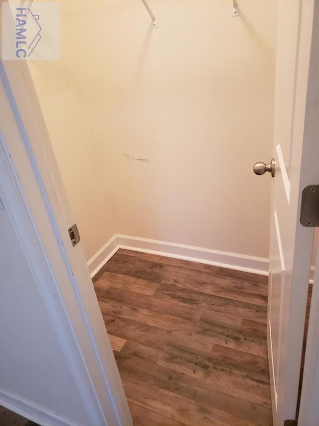 walk in closet featuring dark wood-style floors