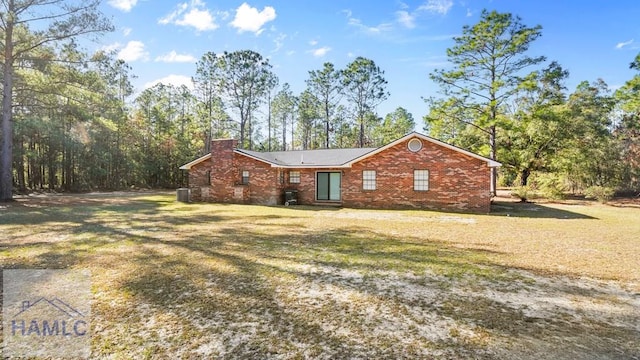 view of front facade with central AC and a front lawn