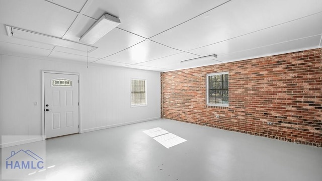 basement featuring brick wall