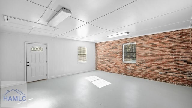 basement featuring brick wall