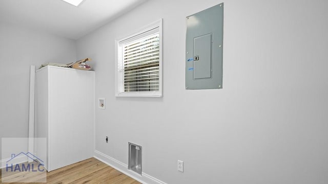 washroom with washer hookup, hookup for an electric dryer, electric panel, and light hardwood / wood-style flooring