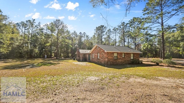 view of side of property with a lawn