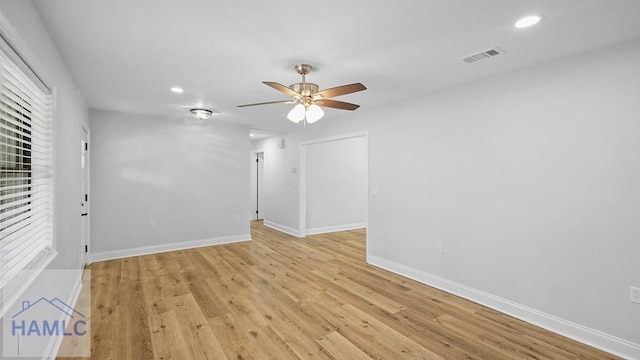 empty room featuring light hardwood / wood-style flooring, ceiling fan, and a healthy amount of sunlight