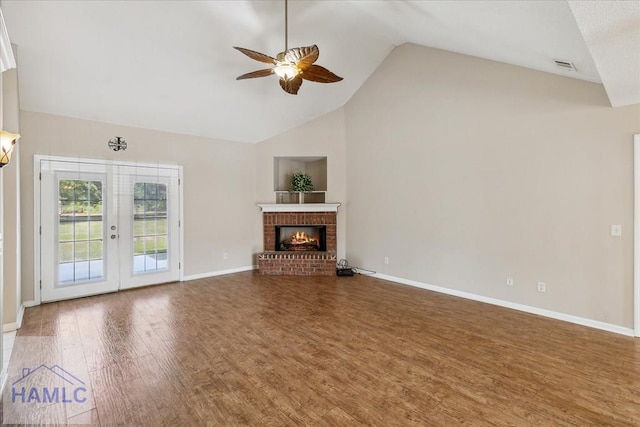 102 Penny Ln, Guyton, GA 31312 - unfurnished living room featuring a ceiling fan, wood finished floors, high vaulted ceiling, baseboards, and a brick fireplace