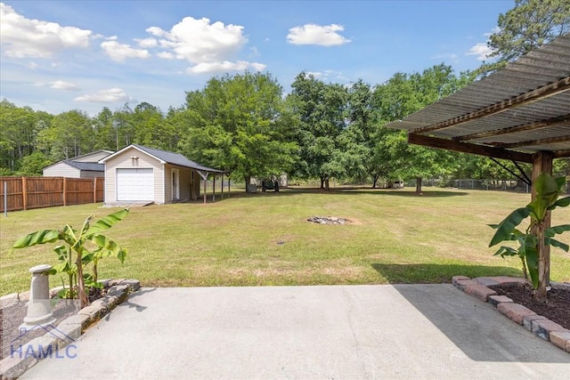 102 Penny Ln, Guyton, GA 31312 - view of yard featuring a garage, an outbuilding, and a patio