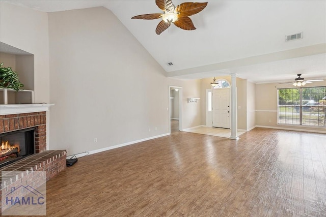 102 Penny Ln, Guyton, GA 31312 - unfurnished living room featuring a ceiling fan, wood finished floors, a brick fireplace, baseboards, and high vaulted ceiling