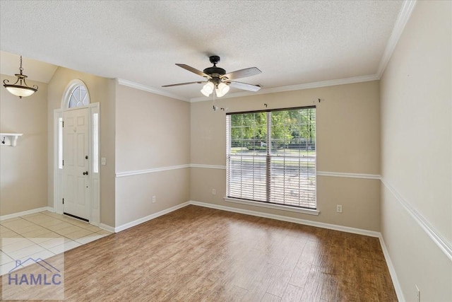 102 Penny Ln, Guyton, GA 31312 - entryway featuring wood finished floors, a textured ceiling, ceiling fan, baseboards, and ornamental molding