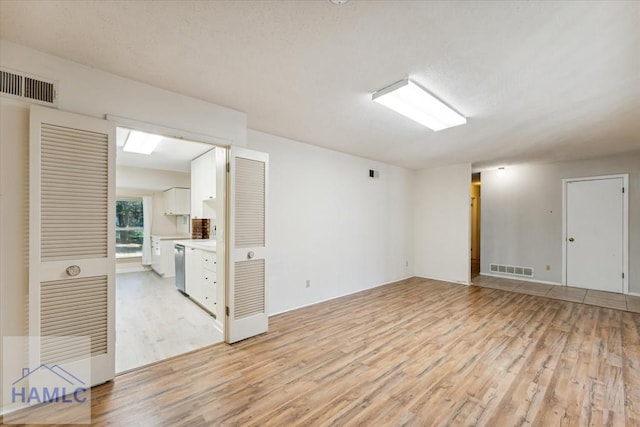 empty room with light hardwood / wood-style flooring