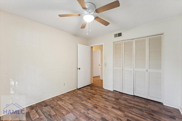 unfurnished bedroom featuring a closet, ceiling fan, and dark hardwood / wood-style flooring