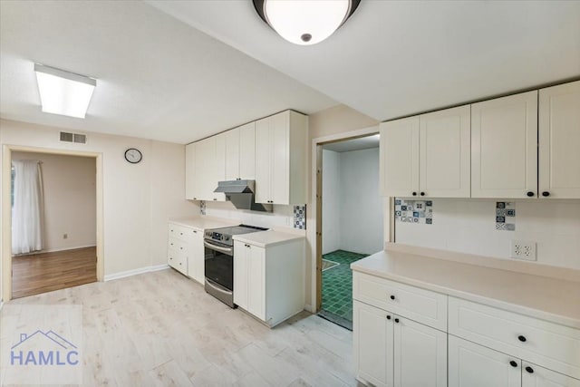 kitchen featuring backsplash, white cabinetry, light hardwood / wood-style floors, and stainless steel range with electric stovetop