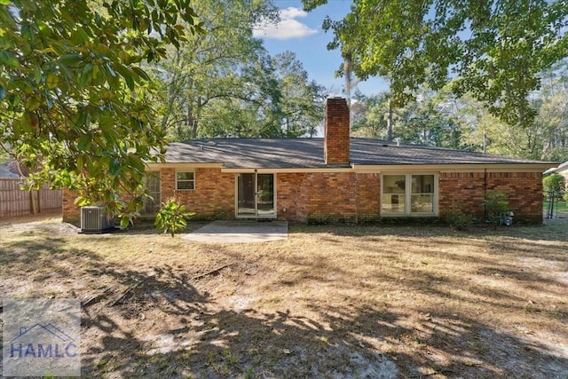 rear view of house featuring a patio and central AC