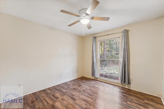 unfurnished room with ceiling fan and dark wood-type flooring