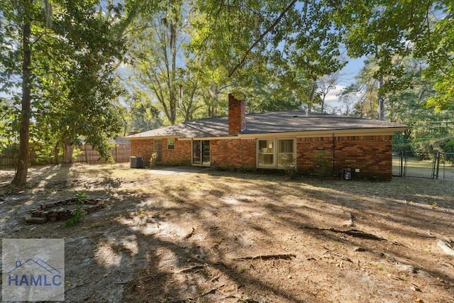 rear view of house featuring central AC unit