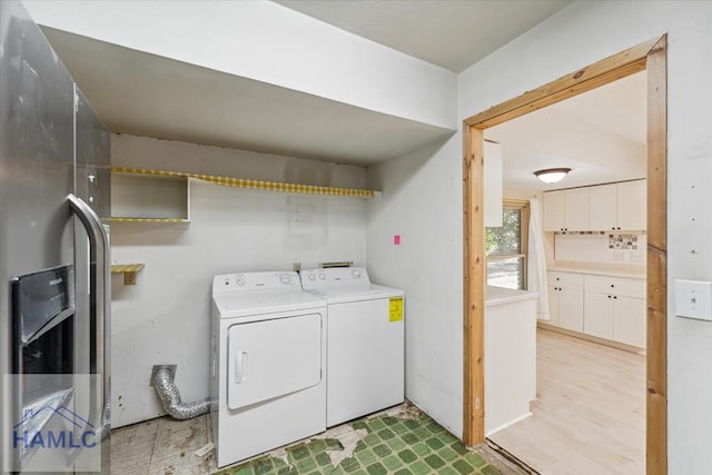 laundry area featuring washer and dryer and light wood-type flooring