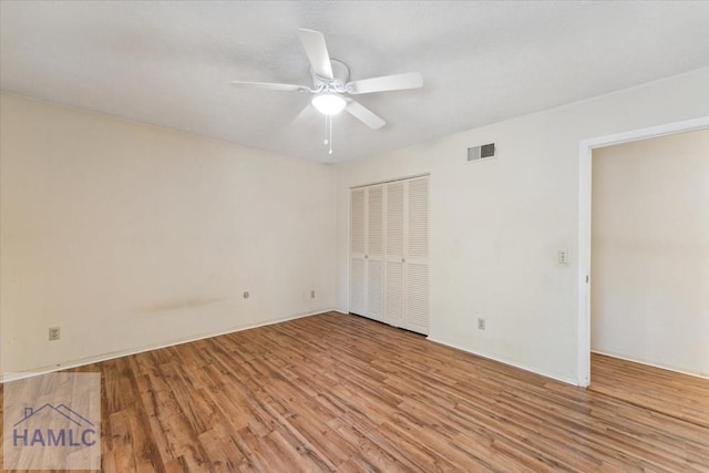 unfurnished bedroom with a closet, light hardwood / wood-style floors, and ceiling fan