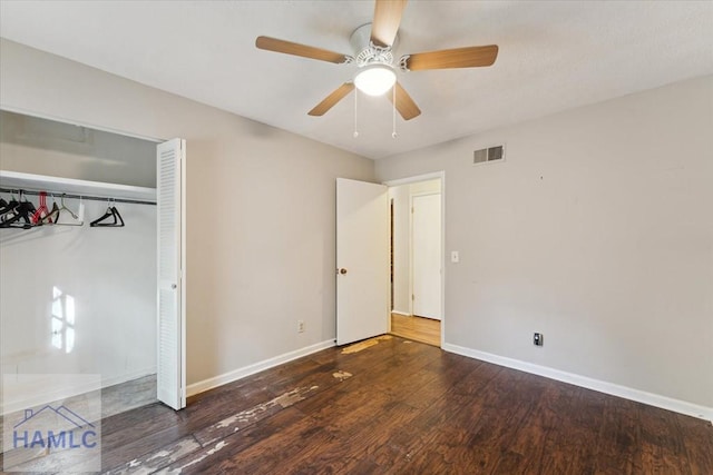 unfurnished bedroom featuring ceiling fan, dark wood-type flooring, and a closet