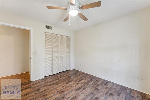 unfurnished bedroom featuring ceiling fan, dark wood-type flooring, and a closet