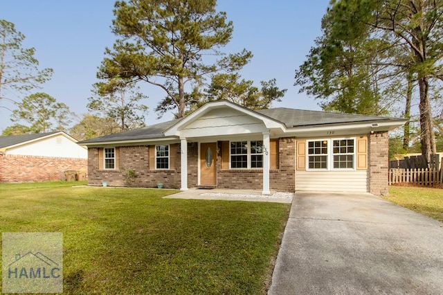 130 Melrose Pl, Rincon, GA 31326 - view of front of home featuring brick siding, fence, a front lawn, and concrete driveway