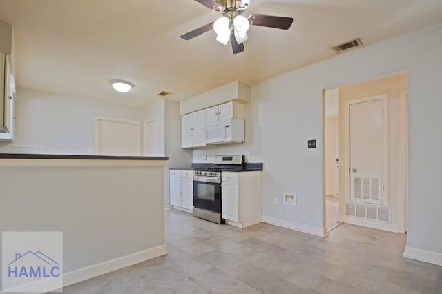 130 Melrose Pl, Rincon, GA 31326 - kitchen with dark countertops, gas range, white microwave, and visible vents