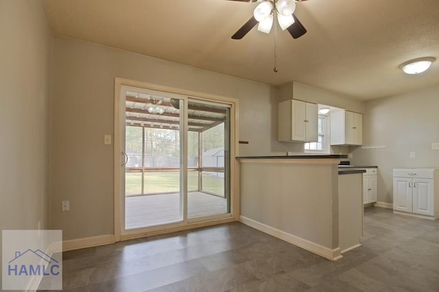 130 Melrose Pl, Rincon, GA 31326 - kitchen featuring white cabinetry, ceiling fan, baseboards, and dark countertops