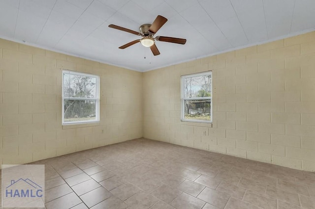 unfurnished room with a wealth of natural light and ceiling fan